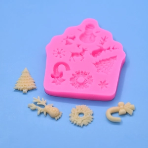 Pink silicone mold featuring Christmas tree, deer and snowflake shapes for DIY cake baking