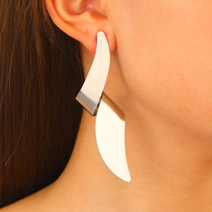 Polished silver irregular geometric wavy fringe earrings with a minimalist sculptural design
