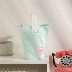 Detail of mint green plush pencil case featuring Hisocute patch and blue zipper
