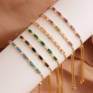 Adjustable gold bracelets featuring vibrant multicolor zircon stones on a white stand