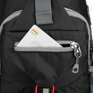 Close-up of black nylon waist bag showing hidden zipper pocket with inserted card