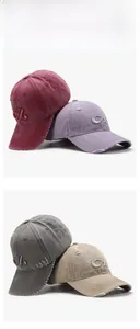 Detailed close-up of distressed baseball caps with 3D embroidery and vintage ripped finish
