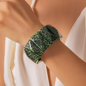 Detail of green leopard acrylic link bracelet with chunky geometric blocks on wrist