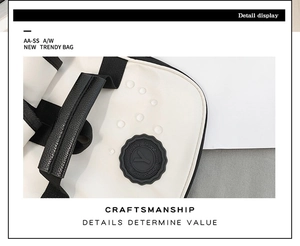 Detail view of white PU leather bag top handle with black nylon webbing and stitching