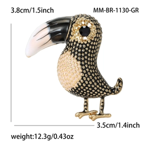 Retro colorful toucan bird brooch with gold and black metal texture on white background
