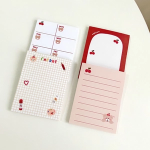 Detail view of cute cherry bear sticky notes including weekly planners and grid paper pads
