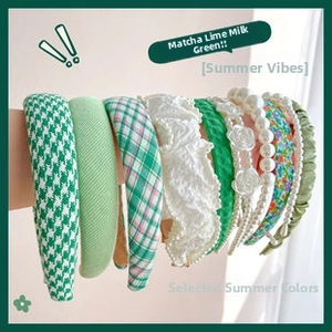 Detail showing assorted summer green headbands with houndstooth, lace, and pearl textures