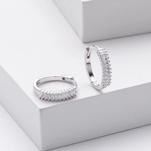Polished S925 sterling silver huggie earrings with rectangular cubic zirconia on white block