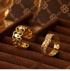Macro shot of gold-plated hollow floral crowns and geometric filigree rings