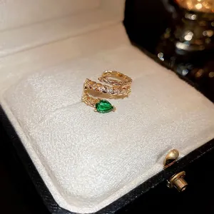 Gold plated snake ear cuff with green zircon stone and sparkling pavé crystals
