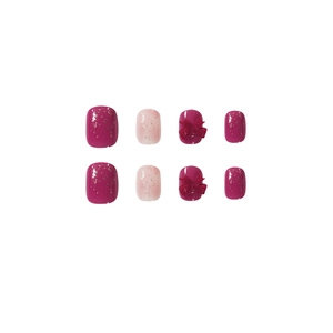 Unghie finte sfumate rosa con glitter e decorazioni a fiocco rosso 3D eleganti