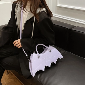 Detail of purple PU leather bat-shaped handbag with silver hardware and shoulder strap