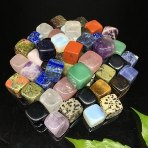 Macro shot of assorted square gemstone beads including amethyst and rose quartz crystals