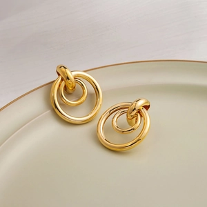 Modern geometric double-layered gold hoop earrings with polished metallic finish