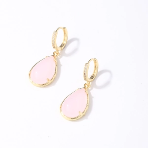 Close-up of pink teardrop gemstone earrings with gold-plated small diamond accents