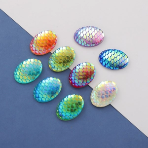 Close-up of 13x18mm oval fish scale resin charms with vibrant AB iridescent finish