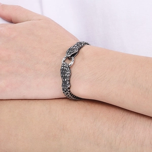 Detail of snake head bracelet in vintage silver with scale texture and gothic style