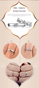 Detail view of silver-plated angel wing couple rings set with cubic zirconia stones