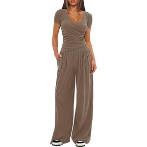 Detail of V-neck wrap top and wide-leg trousers in earthy brown knit fabric