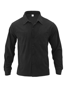 Detail of black corduroy shirt showing classic collar, flap pockets, and ribbed texture