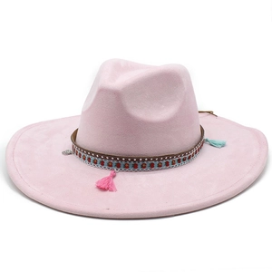 Detail of pink wide brim fedora with ethnic woven band, silver studs and colorful tassels