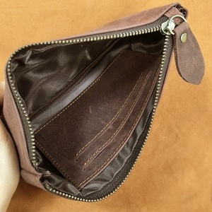 Close-up of brown leather wallet interior showing multiple card slots and fine stitching