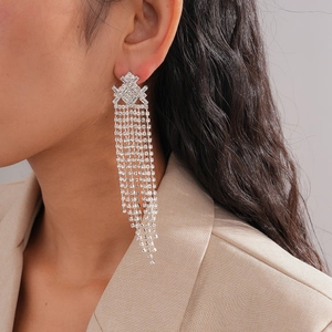 Sparkling silver rhombus tassel earrings with cubic zirconia on a female model