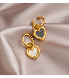 Macro detail of double-sided heart earrings with black and white mother of pearl inlay