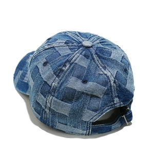 Detail of blue denim baseball cap with checkered texture and metal adjustable strap