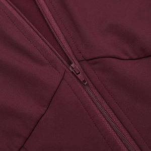 Detailed close-up of the high-quality invisible zipper on burgundy yoga set fabric