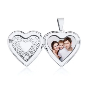 Macro shot of silver heart locket pendant showing interior photo frame and engraving