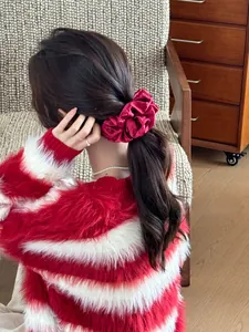 Close-up of rose red satin scrunchie styled on a ponytail for a voluminous look