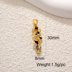 Macro shot of 18K gold plated snake charm with black enamel and zircon inlay details