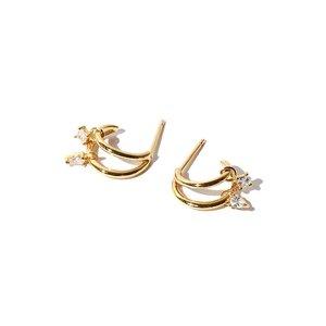 Macro shot of minimalist gold double hoop earrings featuring drop and square cut zircons