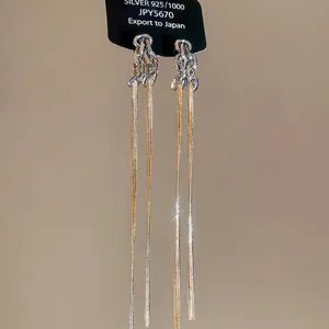 Boucles d'oreilles nœud en argent S925 avec longues chaînes à pompons dorées