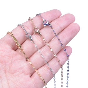 Detail view of four stainless steel chains in gold, silver, rose gold and rainbow colors