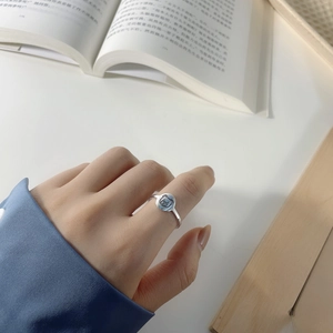 Close-up of S925 sterling silver mini cartoon bear ring worn on a woman's finger