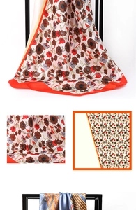 Detail of silk satin square scarf with cream sunflower print and vibrant orange border