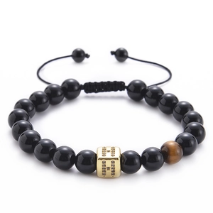 Detail of tiger eye and onyx bead bracelet with zircon H initial square pendant