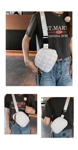 Detailed view of a white quilted down crossbody bag featuring adjustable wide shoulder strap