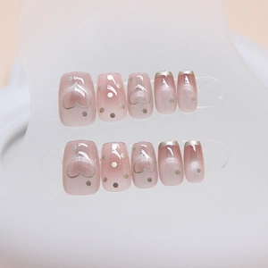 Cat eye press-on nails with pink gradient heart design and French silver edges