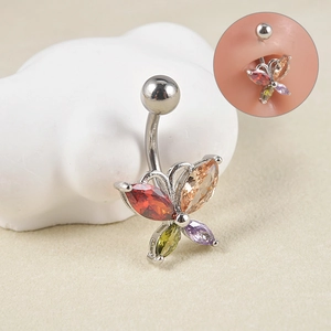 Macro detail of butterfly belly button ring with colorful zircons on white stone