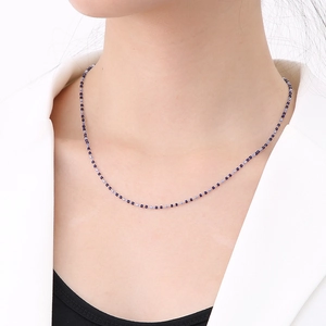 Bohemian stainless steel beaded necklace with dark blue and lilac enamel drops on model
