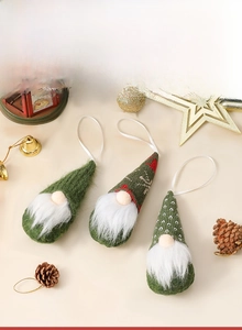 Three knitted Christmas tree gnomes in moss green with white beards and festive props