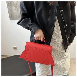 Gothic red bat wing handbag for women with metallic ring handle and crossbody strap