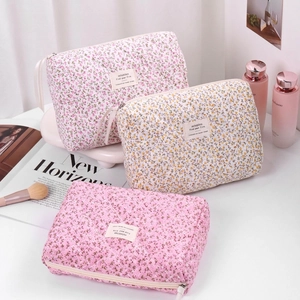 Pastel cherry blossom quilted makeup bags in pink and beige colors for travel
