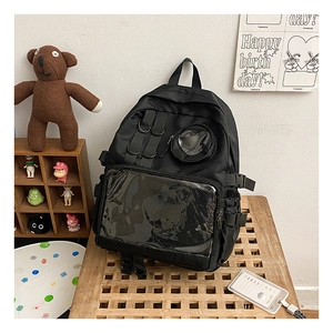 Close-up of black nylon backpack with a transparent PVC window and side buckle detail
