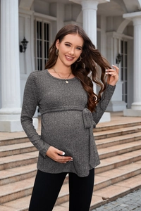 Detail of grey knitted maternity sweater with adjustable waist belt and fine texture