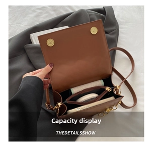 Interior view of the caramel brown leather bag showing multi-compartment storage space