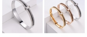 Detail of tarnish-free stainless steel bangle with rhinestone and black line accents